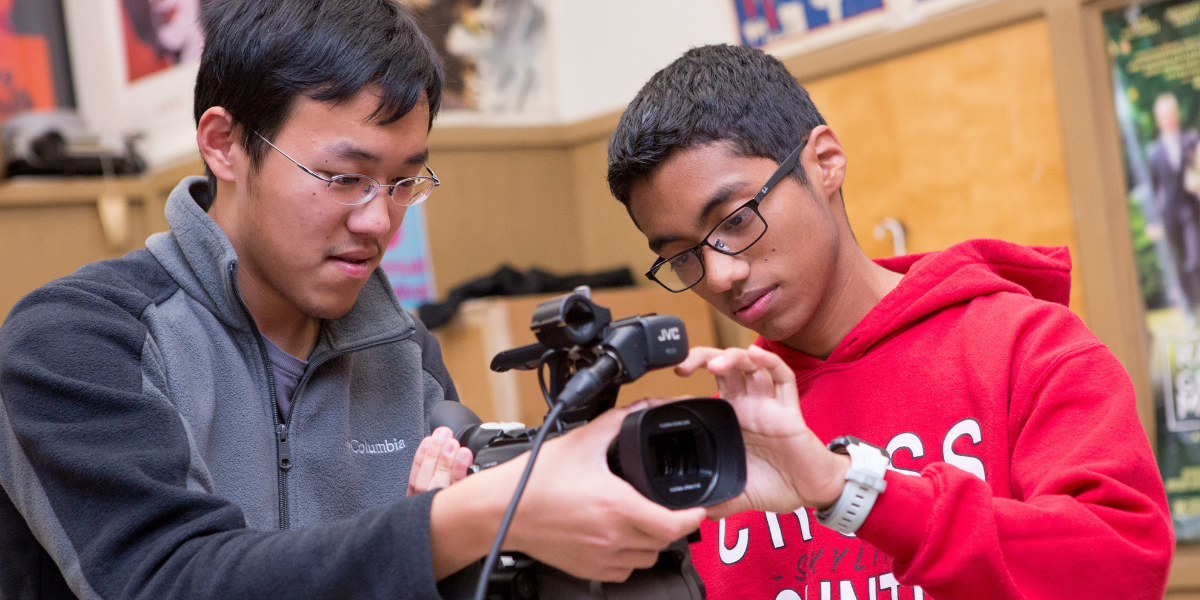 Image of two students looking at a camera.